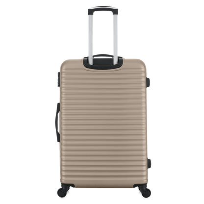 Grande valise noire de dos
